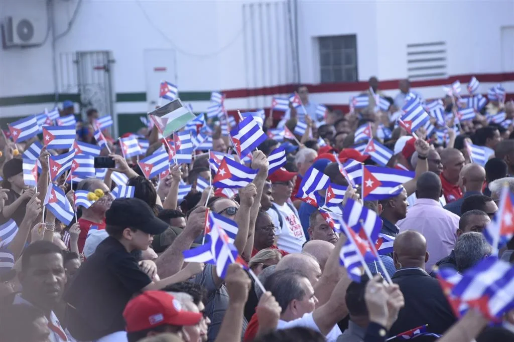 A crowd waves Cuban flags during an open-air rally.